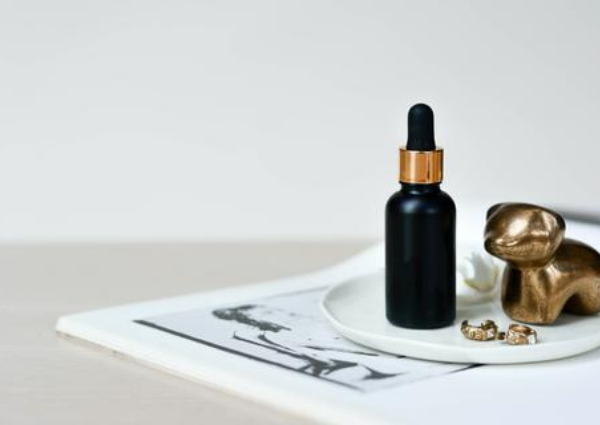 black serum bottle sitting on a trinket dish