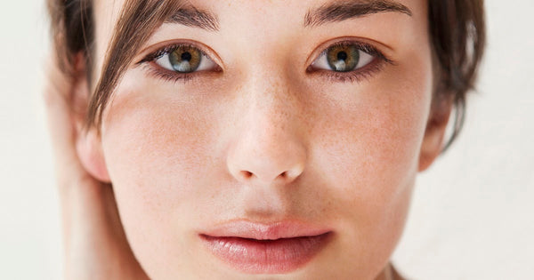 Young woman with clear, glowing skin after using hyaluronic acid serum