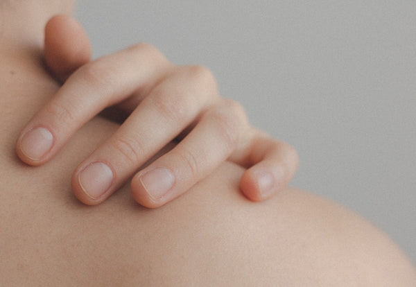 Close up of woman’s hand moisturising her skin